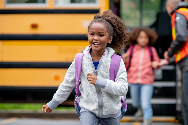 girl getting off bus